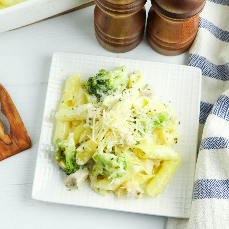 A serving of chicken alfredo casserole on a white plate.