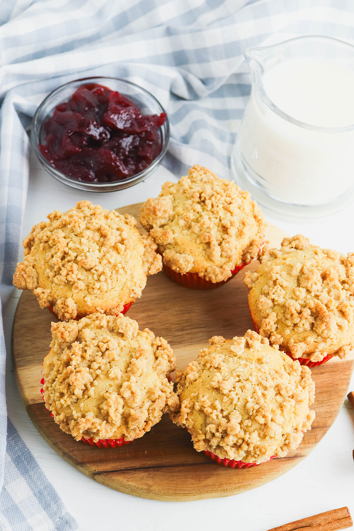 Cranberry Sauce Muffins on a round wooden serving board.