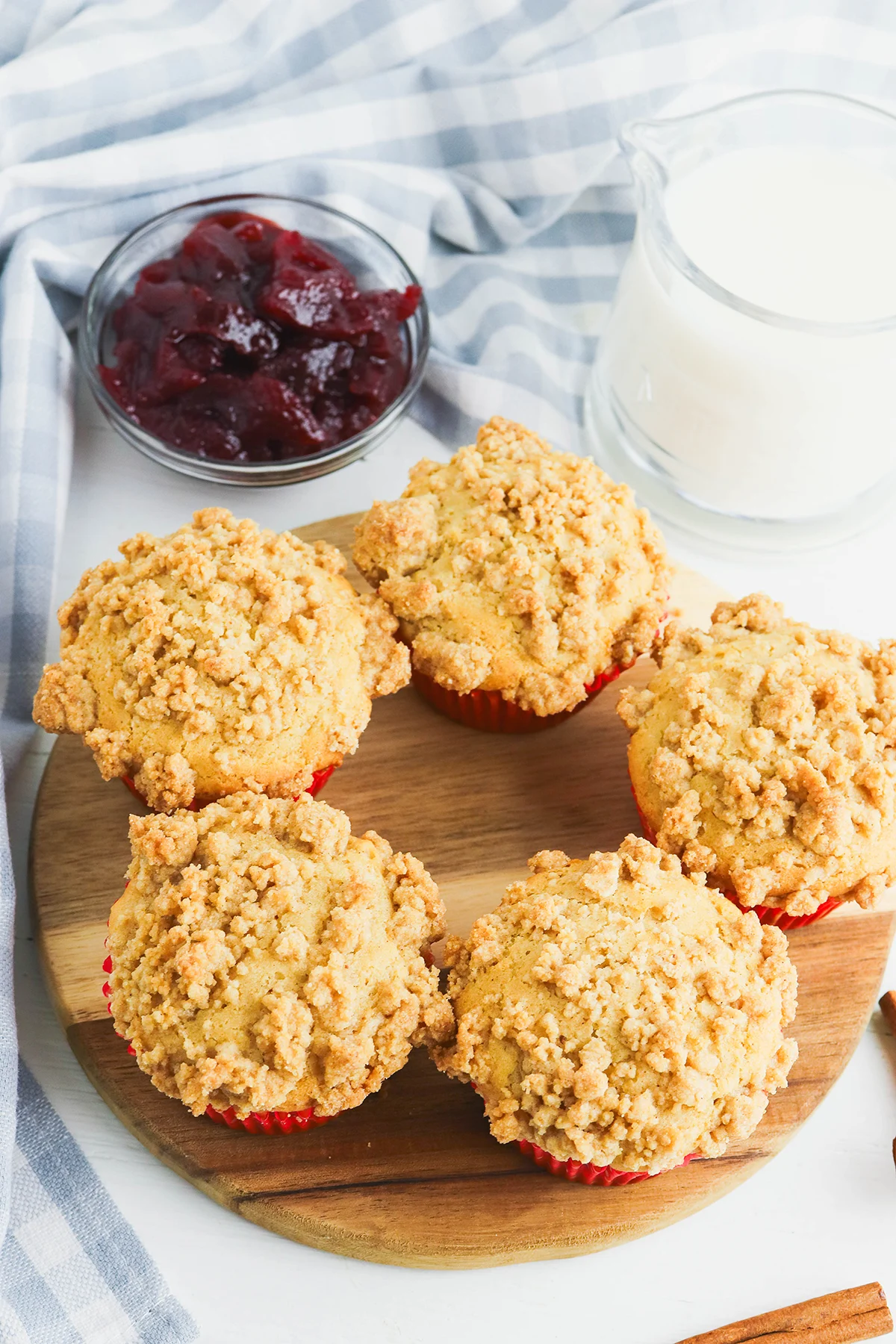 Cranberry Sauce Muffins on a round wooden serving board.