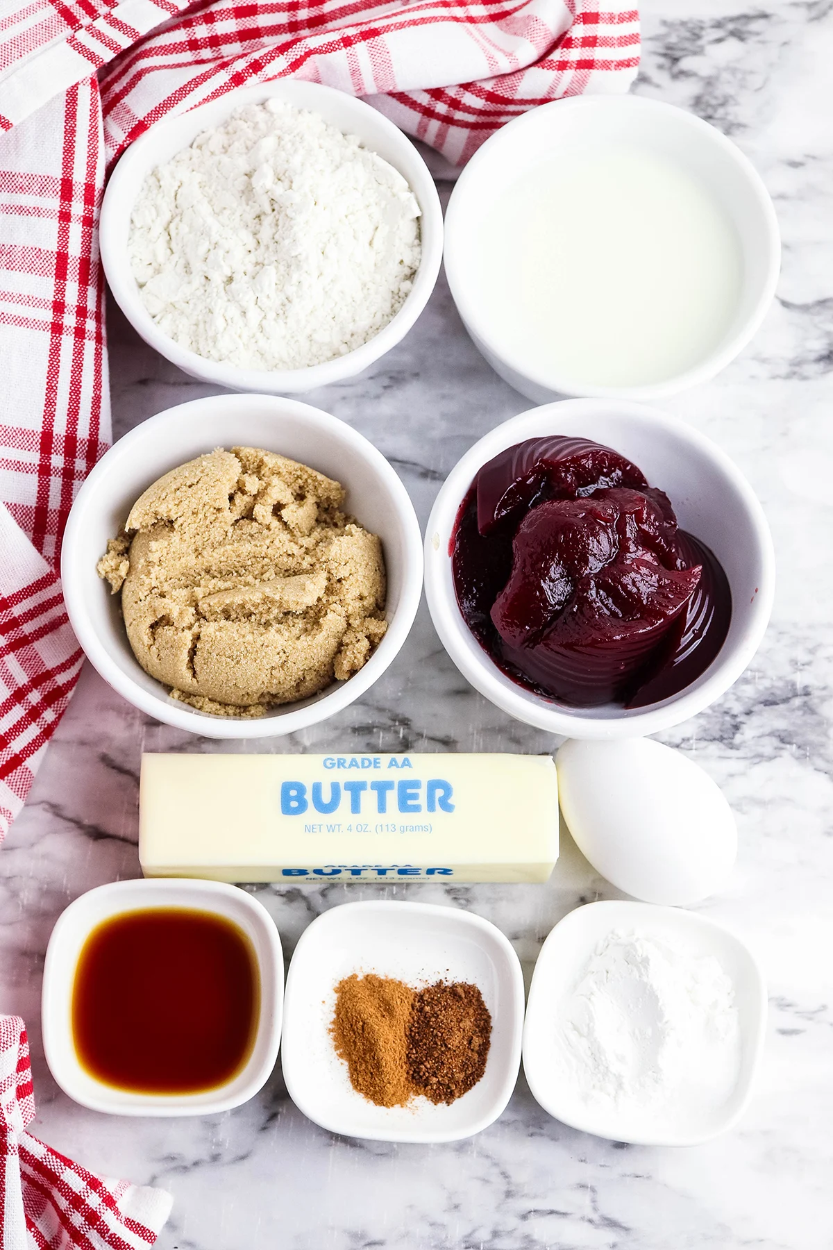 Ingredients to make cranberry sauce muffins set out on the counter.