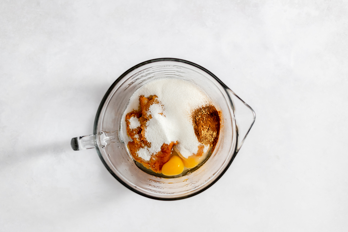 Ingredients to make mini pumpkin pies in mixing bowl.
