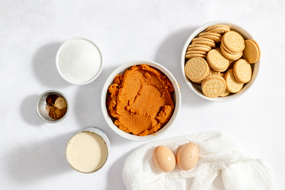 Ingredients to make mini pumpkin pies set out on counter.