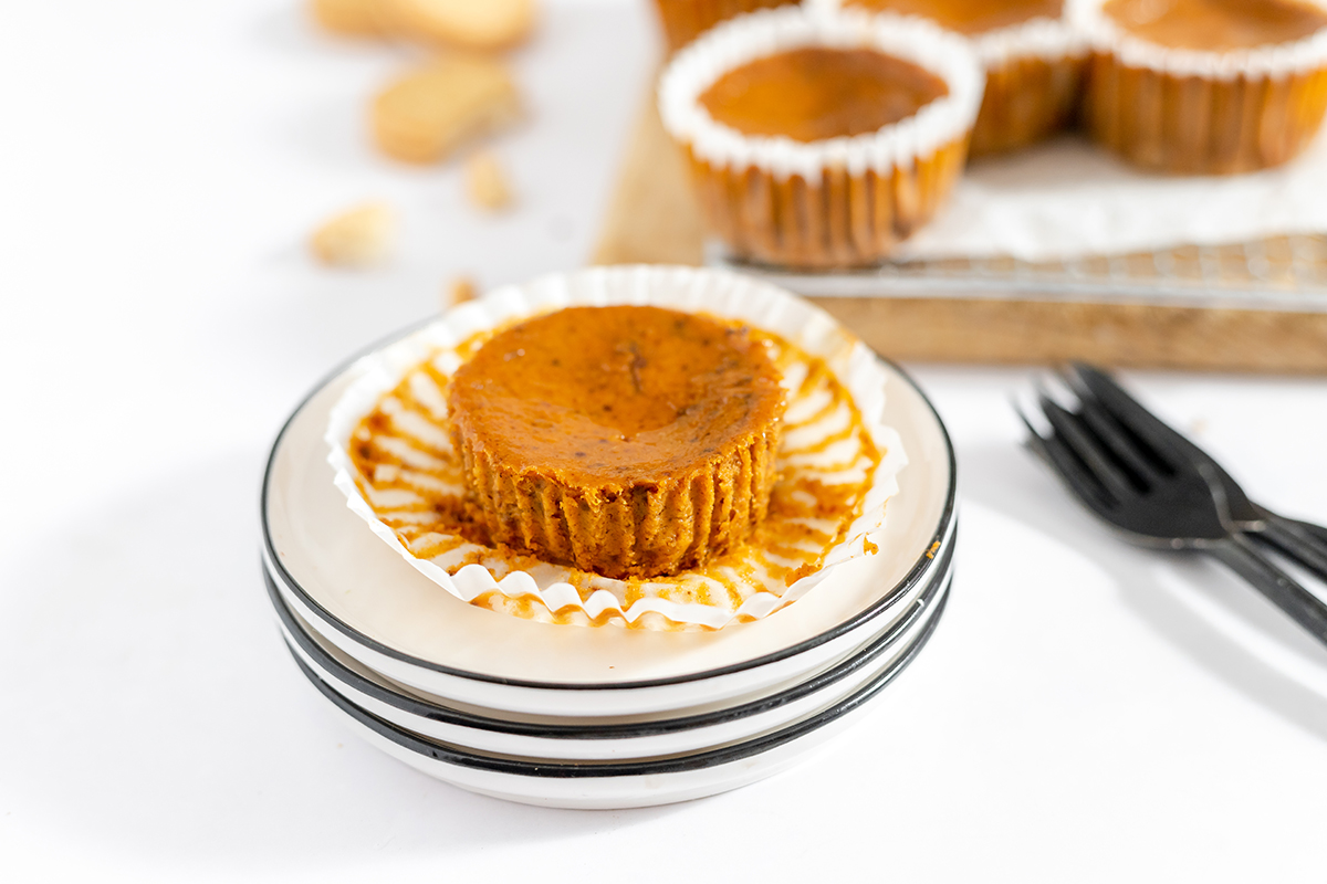 One mini pumpkin pie on white plate.