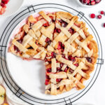 Cranberry Apple Pie in pie plate on wire rack.