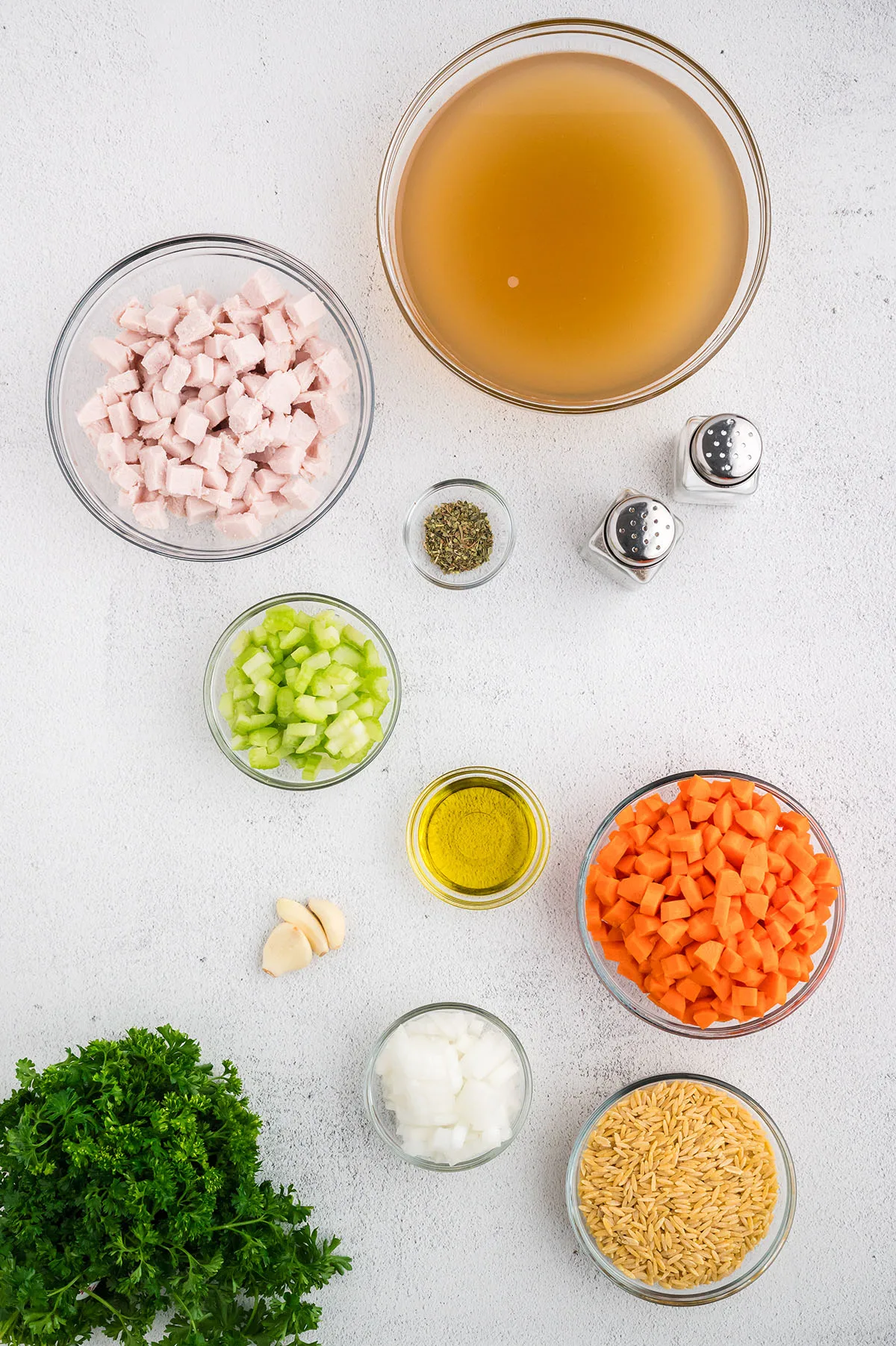 Ingredients to make Turkey Orzo Soup set out on the counter.