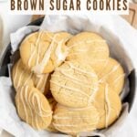 Maple Brown Sugar Cookies stacked in a round container on a wooden serving board.
