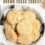 Maple Brown Sugar Cookies stacked in a round container on a wooden serving board.
