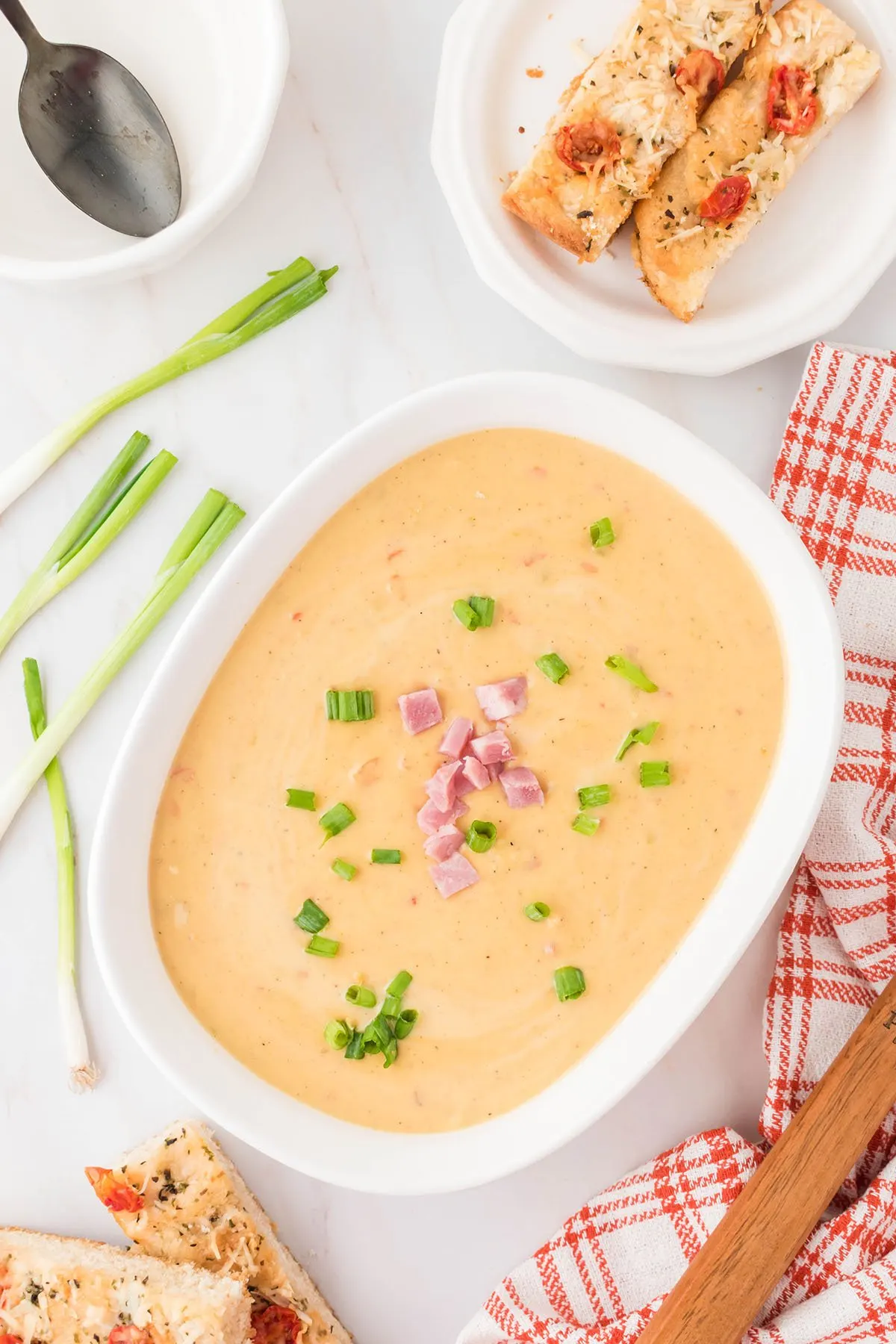 Cheese soup in a white serving dish.