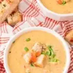 Cheese soup served in a bowl topped with croutons.