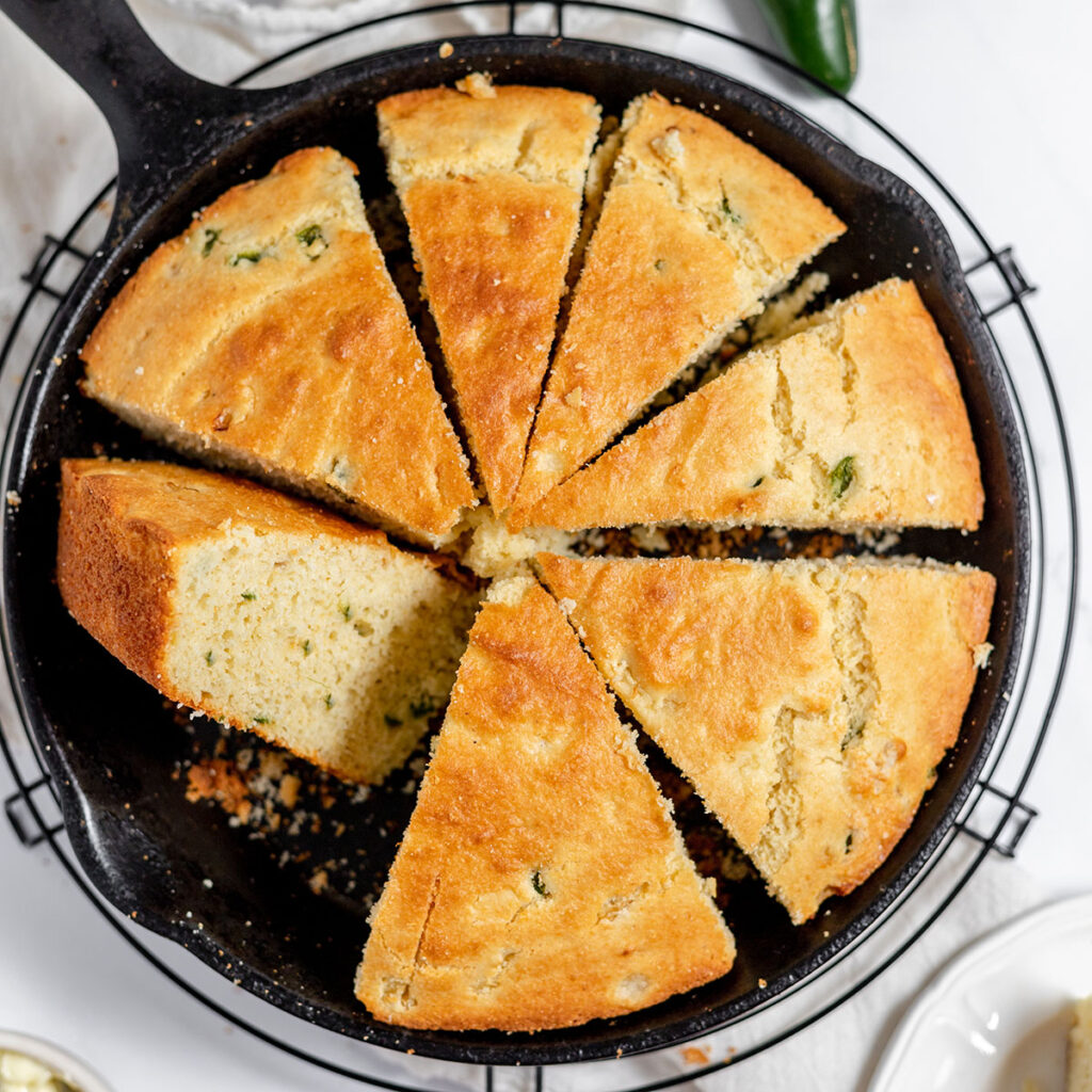 Jalapeno Cornbread slices in a cast iron skillet.