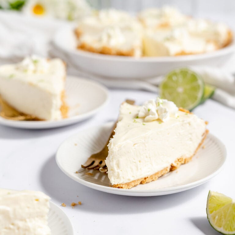 Slice of Key Lime Pie on a white plate.
