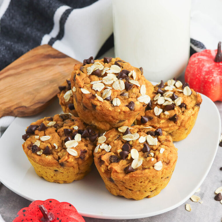 Pumpkin Oat Muffins stacked on a white plate.