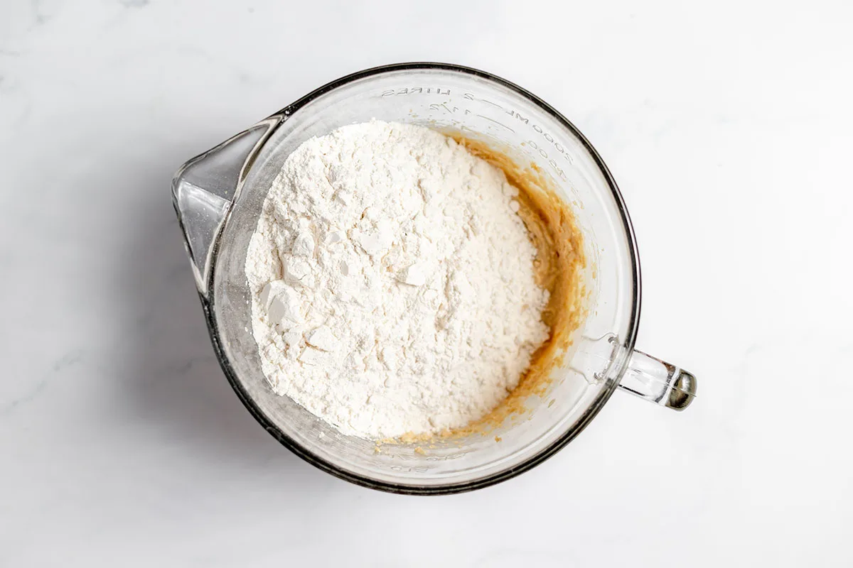 Flour mixture added to the wet ingredients in the mixing bowl.