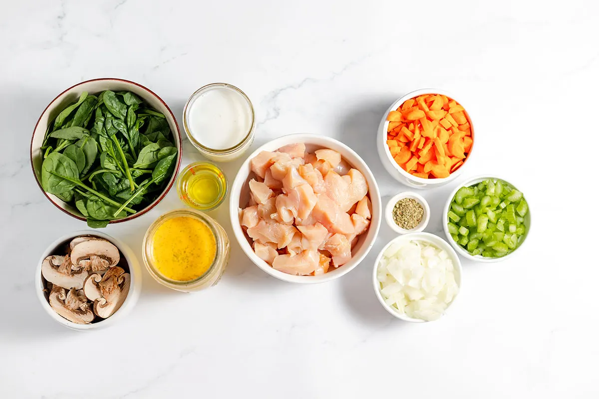 Ingredients to make chicken mushroom soup set out on the counter.