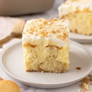 A slice of Banana Pudding Poke Cake on a plate.