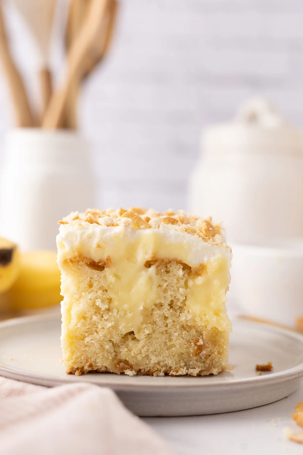 Slice of Banana Pudding Poke Cake on a plate.