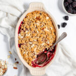 Blackberry Crisp in a baking dish with a spoon.
