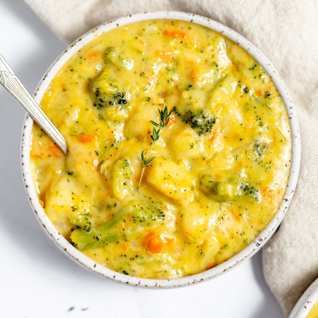 Broccoli Potato Cheese Soup in a bowl with a spoon.