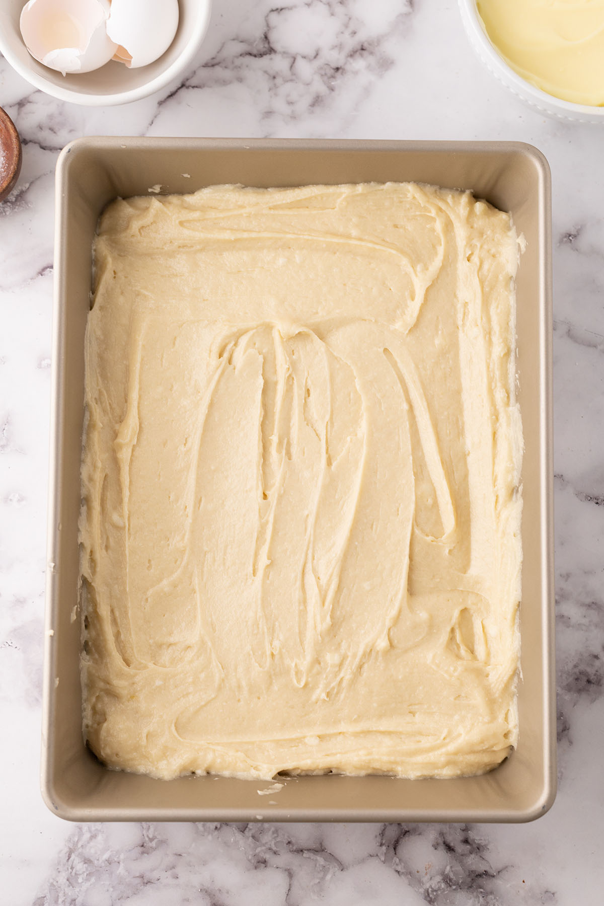 Cake batter in a baking pan.