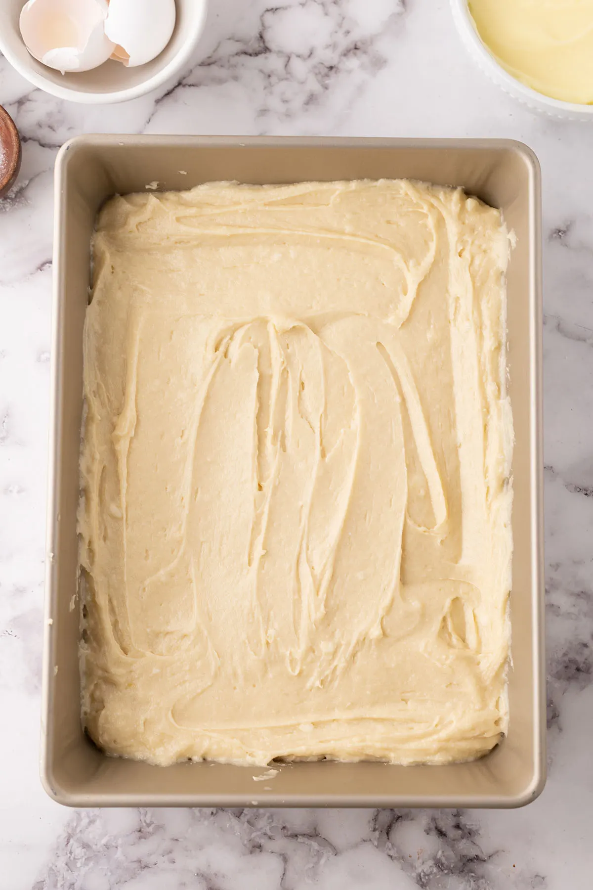 Cake batter in a baking pan.