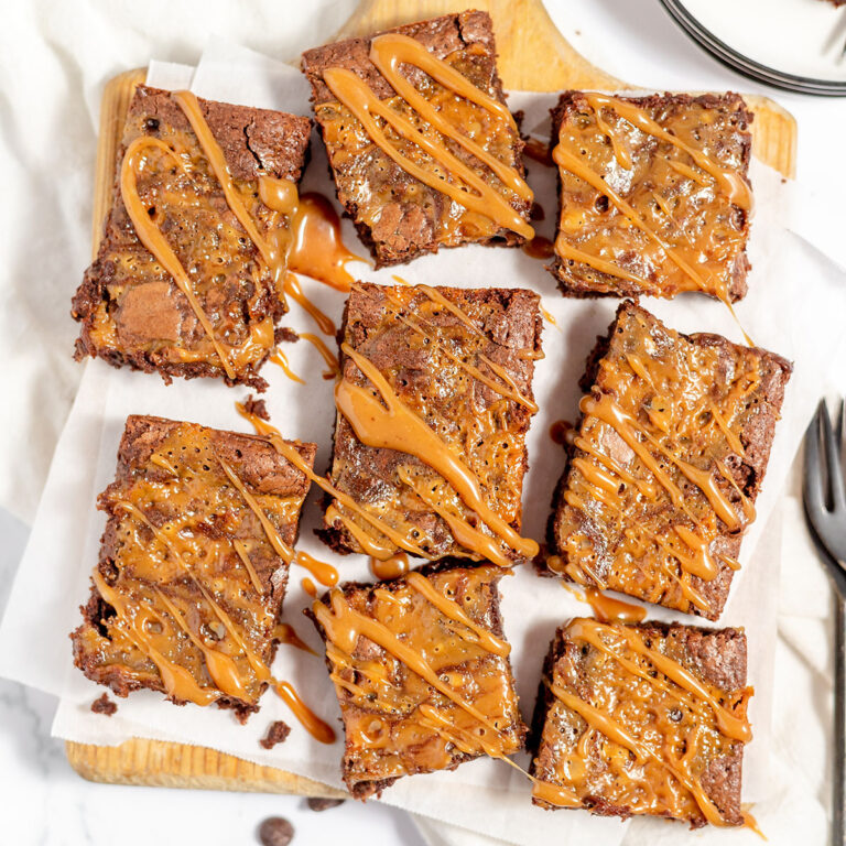 Caramel Brownies served on a wooden serving board.