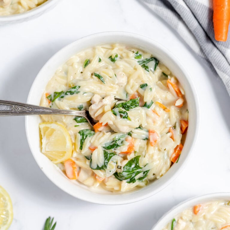 Creamy Lemon Chicken Orzo Soup in a white bowl.
