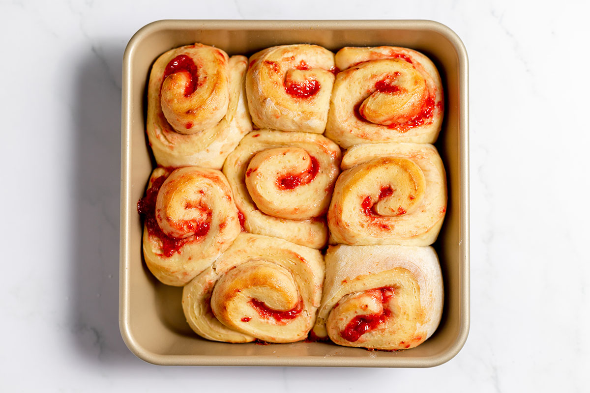 Baked Strawberry Cinnamon Rolls in a baking pan.