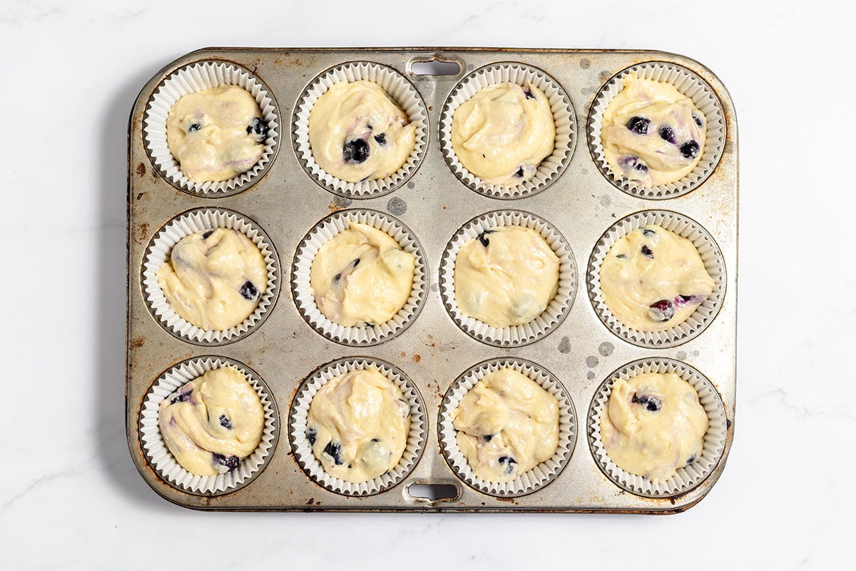 Blueberry Lemon Muffin batter in a muffin pan.