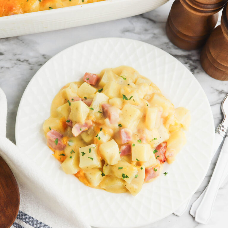 A serving of Ham and potato casserole on a white plate.
