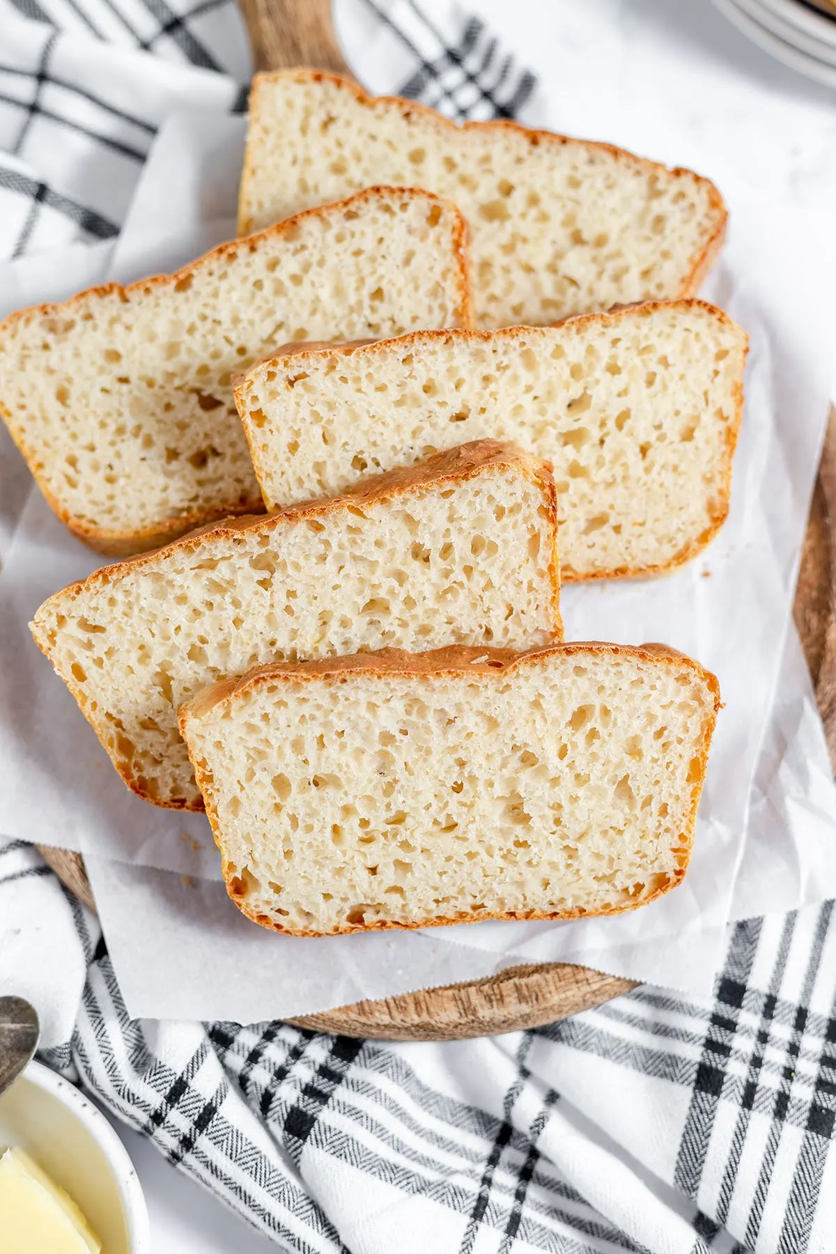 English Muffin Bread Slices on a wood serving board.