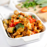 Kung Pao Chicken is served in a square white dish.