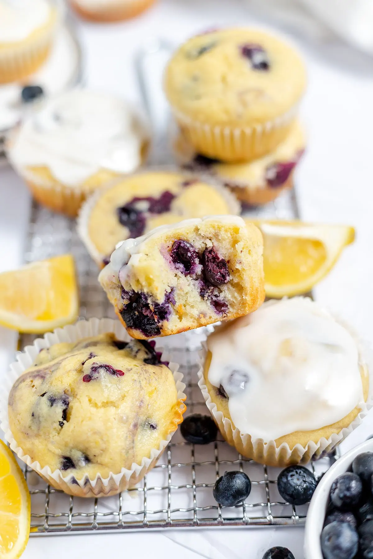 Blueberry lemon muffins on a wire rack.