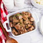 Beef Tips in a white serving dish.