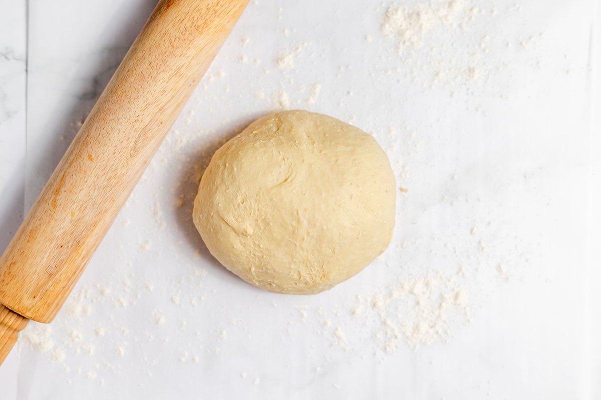 Strawberry Cinnamon Roll on floured parchment paper.