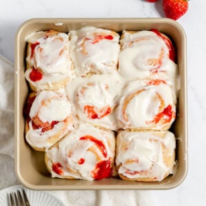 Strawberry Cinnamon Rolls in a square baking pan.
