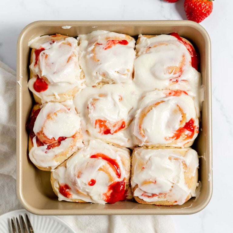 Strawberry Cinnamon Rolls in a square baking pan.