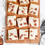 White Texas Sheet Cake is served on a wooden serving board.
