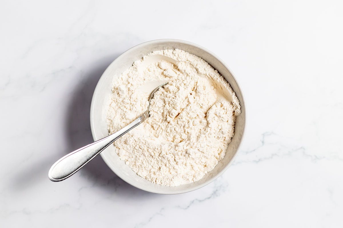 Flour, baking powder, and salt in a bowl.