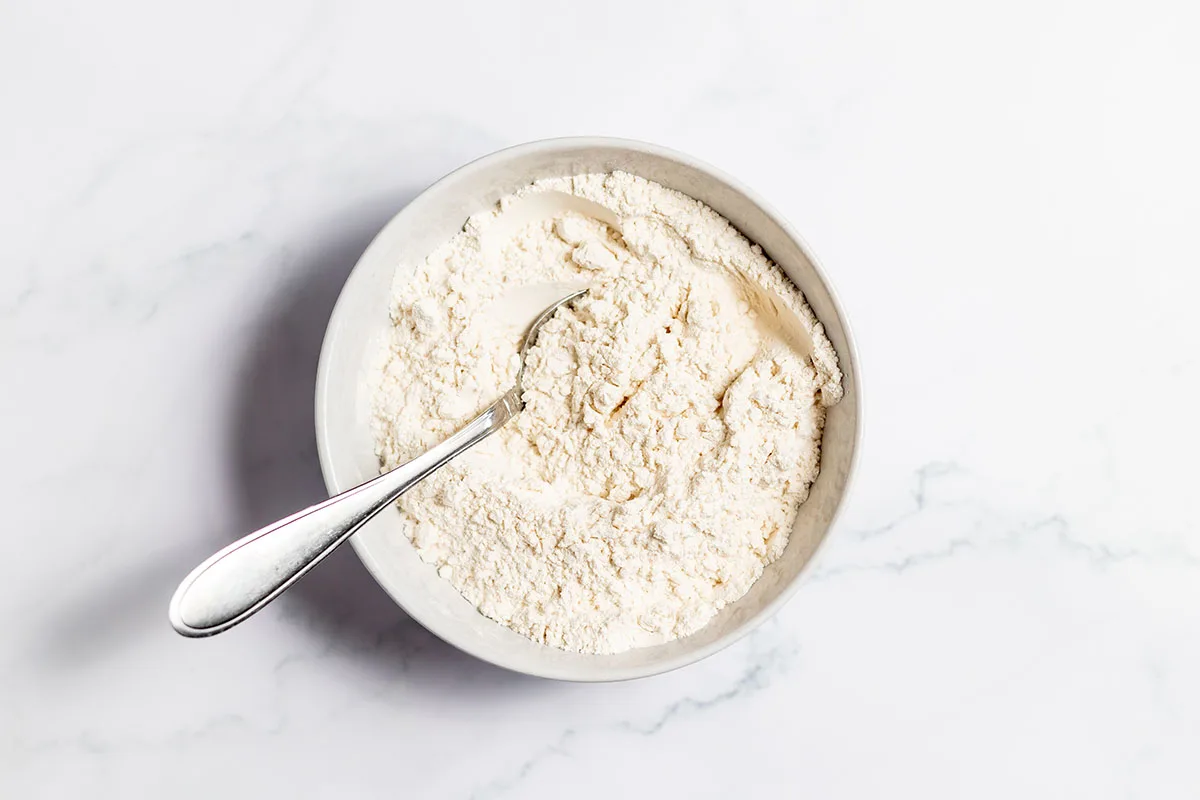 Flour, baking powder, and salt in a bowl.