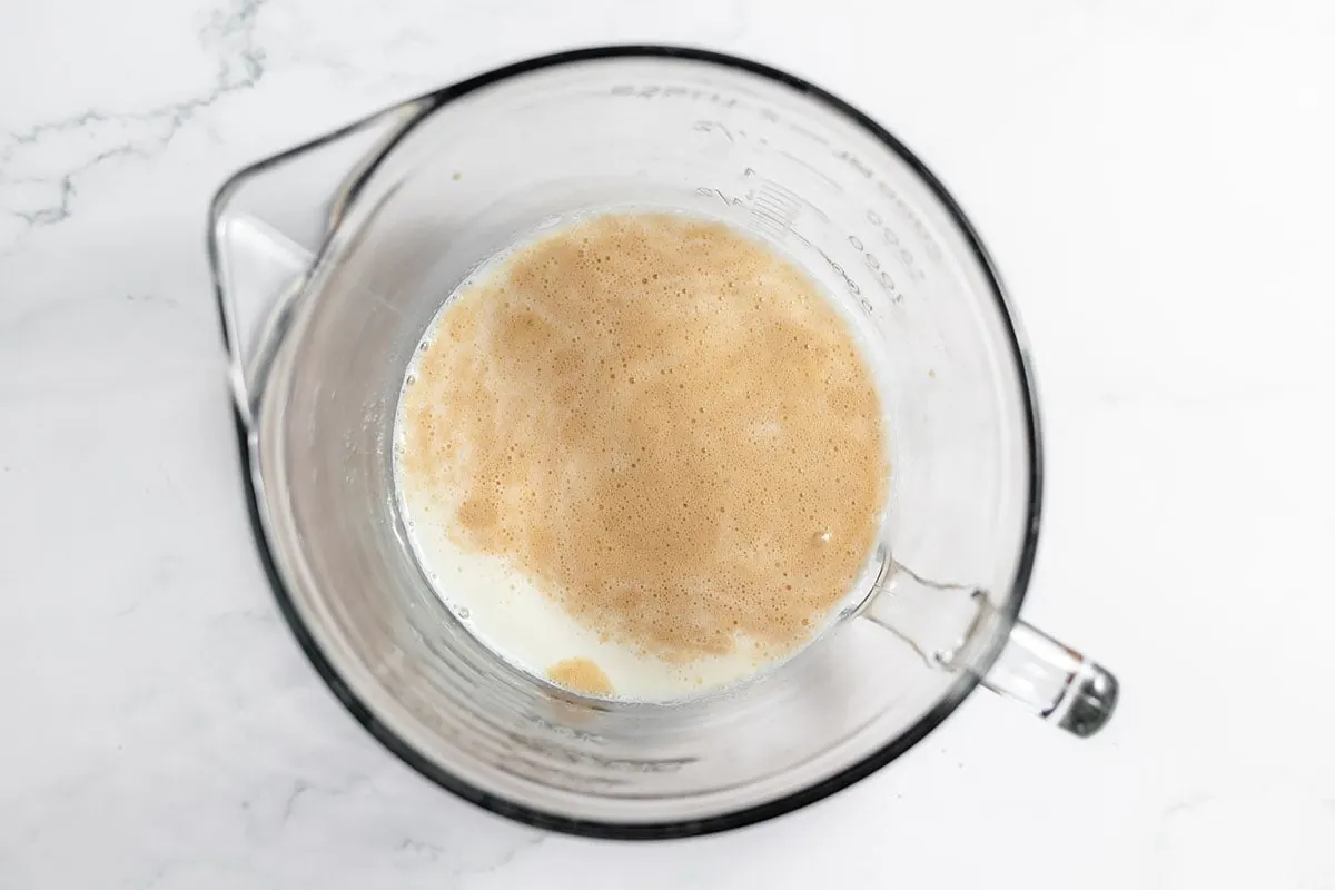 Milk and yeast in a mixing bowl.
