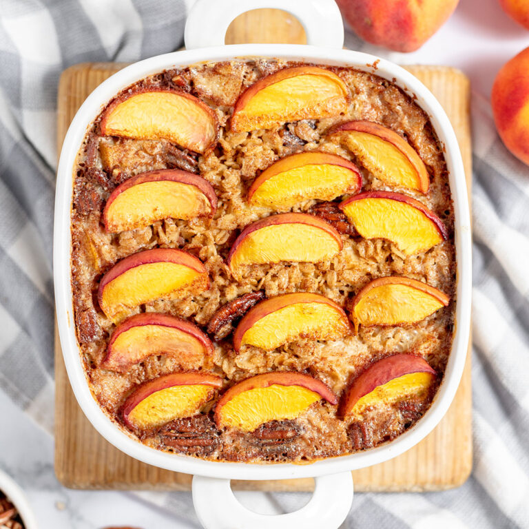 Peach Baked Oatmeal in a white baking dish.