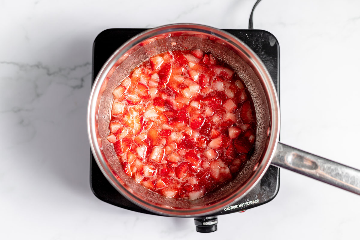 Strawberries, sugar, and lemon juice in a saucepan.