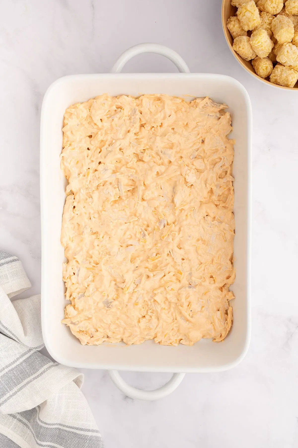 Buffalo chicken filling was added to the baking dish.