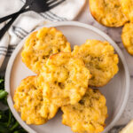 Five Mac and cheese cups on a plate.