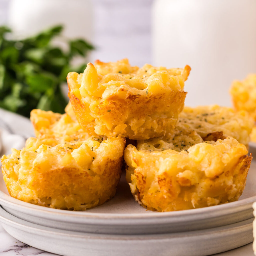 Macaroni and cheese bites stacked on a plate.