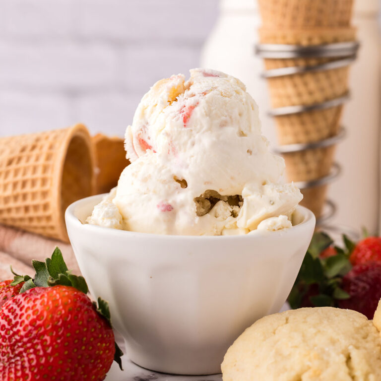 Scoops of Strawberry Shortbread Ice Cream in a white dessert bowl.