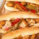Chicken Philly sandwiches on a white platter.