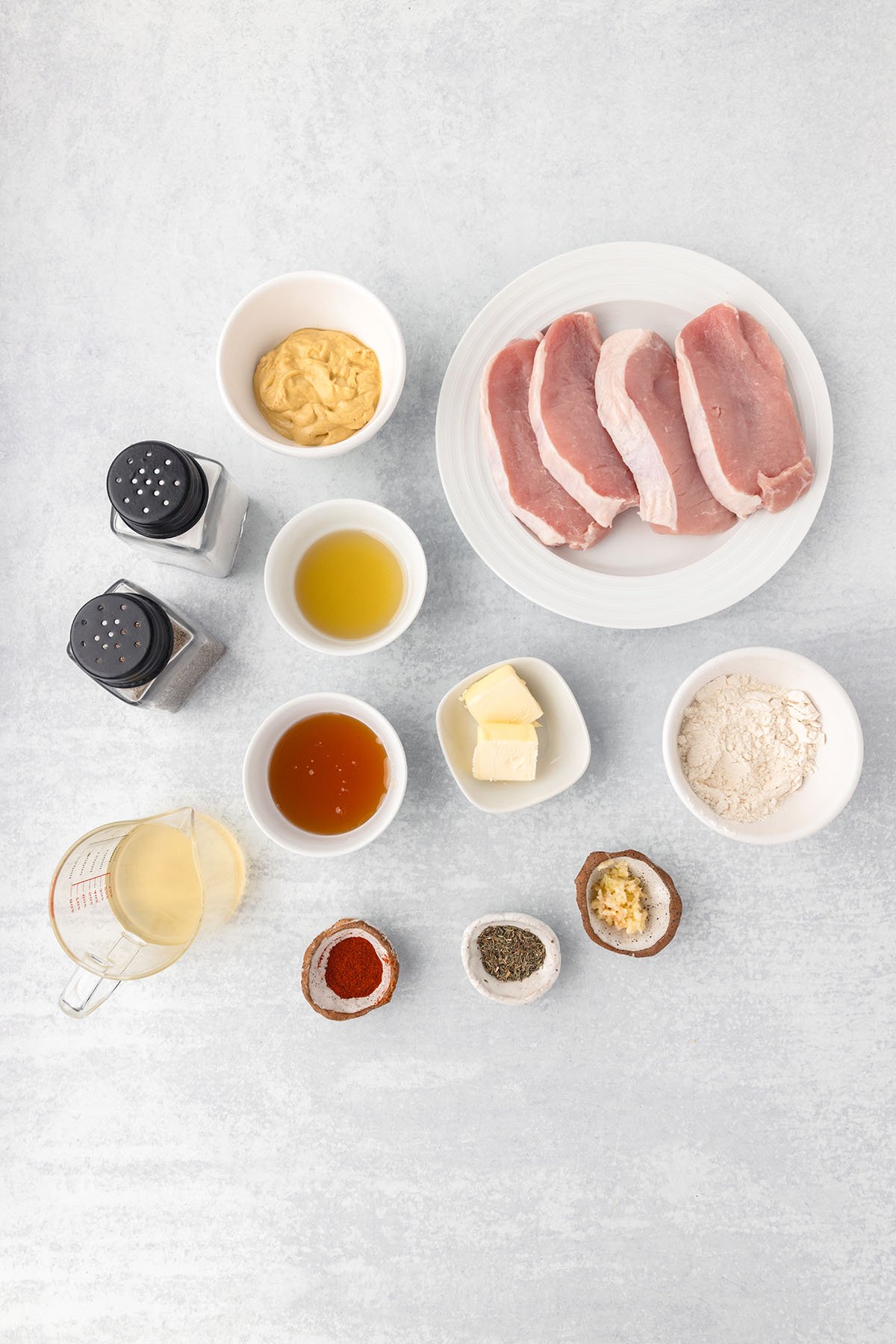 Ingredients to make Honey Mustard Pork Chops set out on the counter.
