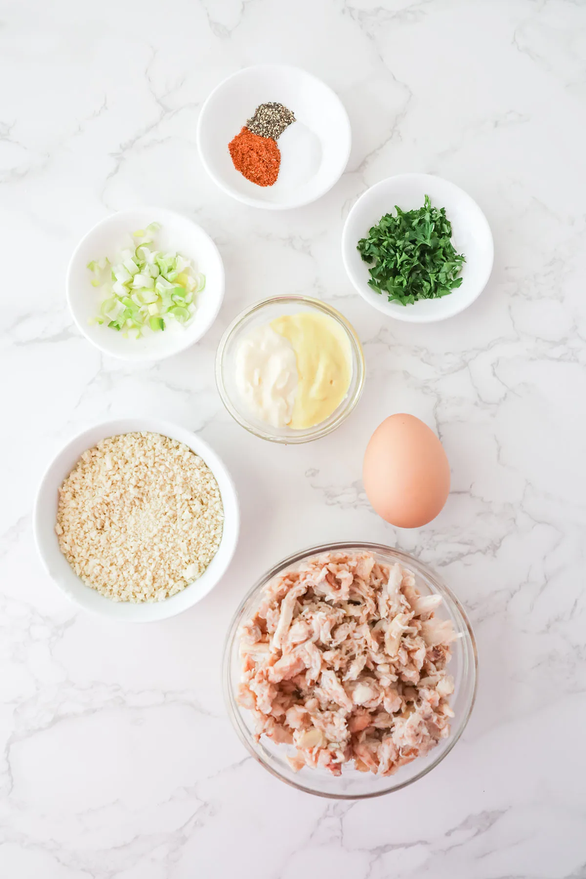 Ingredients to make crab cakes set out on the counter.