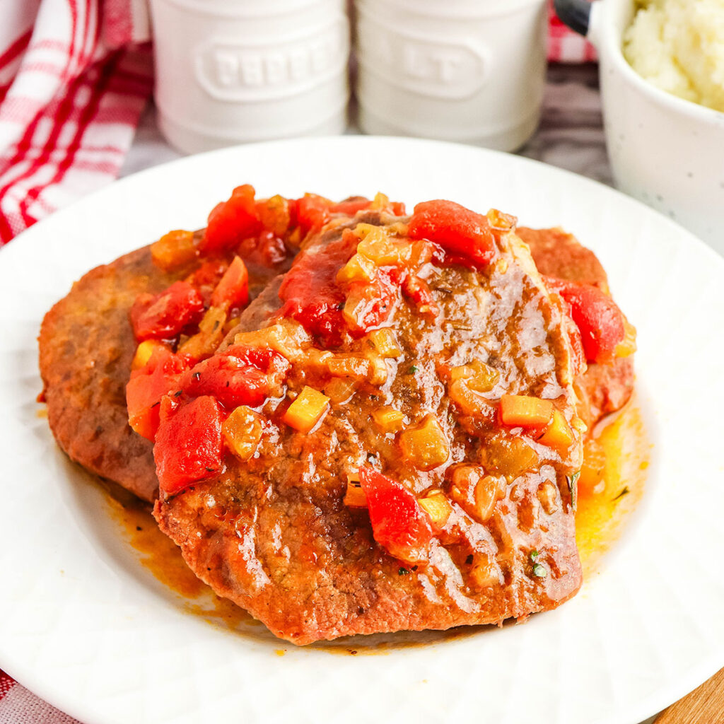 Swiss Steak served on a white plate.